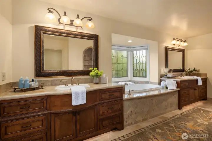 Primary bath offers a retreat-like experience with a spacious walk-in shower, premium fixtures, heated floors & a deep soaking tub.
