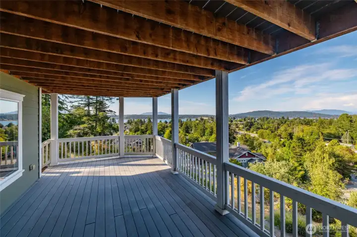 Lower deck offers views and steps to the backyard and trails below.