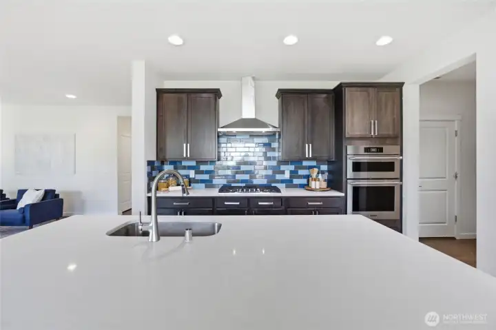 The heart of the home features an oversized island, abundant workspace, and room for everyone to gather.