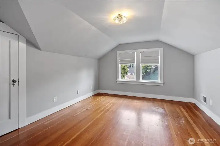 One of two upstairs bedrooms with fir flooring