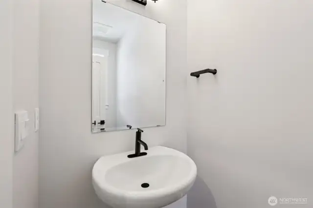 Convenient powder room on the main level for guests highlighted by a pedestal sink.