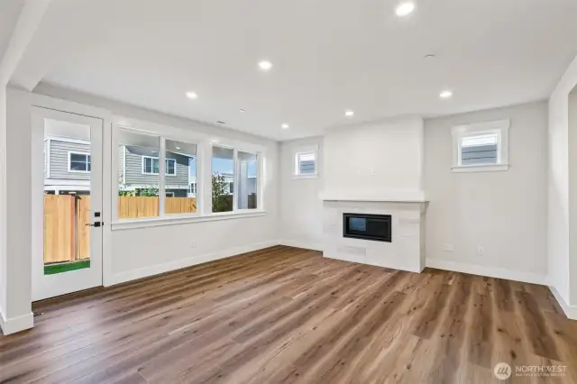 Great room is filled with light from an abundance of windows and opens directly to the covered patio in the rear yard.