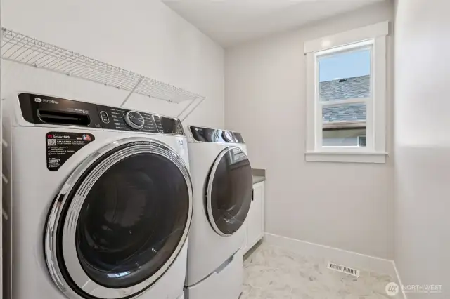 Desirable 2nd floor laundry room with utility sink and GE washer/dryer with pedestals included!