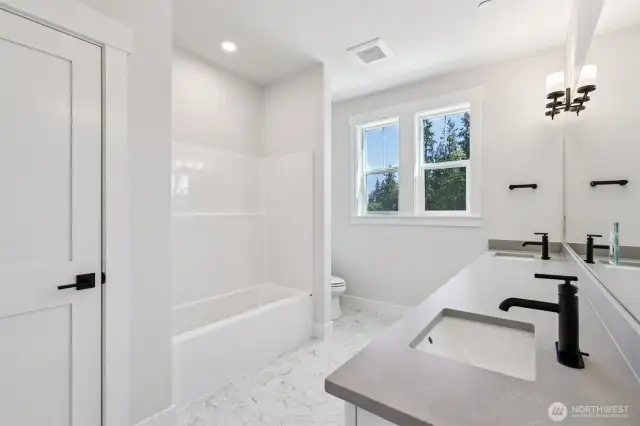 Expansive hall bath with tub/shower combo and large linen closet.