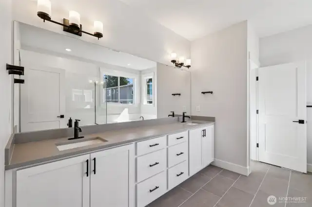 Primary bath with dual vanity and private toilet closet.