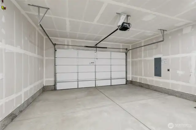 Two car, side by side garage with car charger outlet.