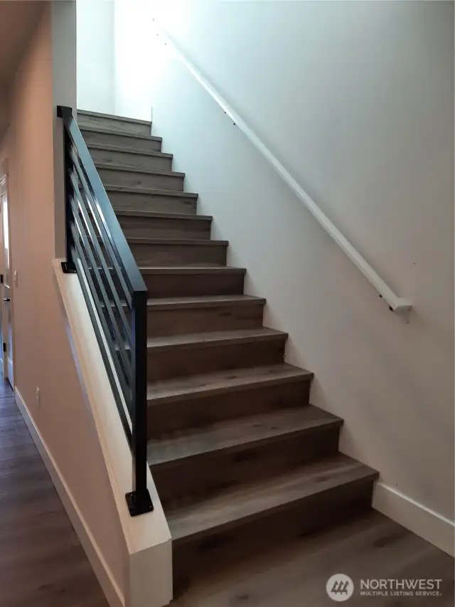 Light filled staircase leads to upper loft, highlighted by 9ft. ceilings