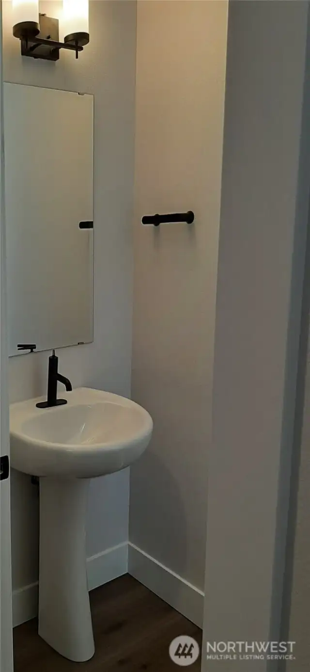 Elegant powder room at entry.