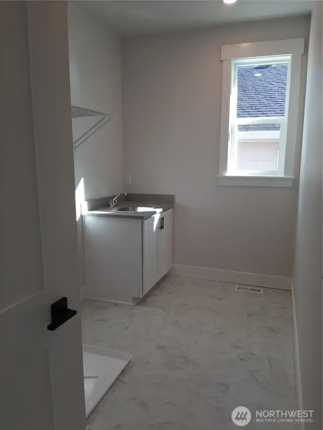 Convenient second level laundry room with utility sink