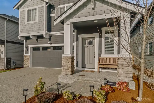 Gorgeous covered entry with 2 car garage and driveway for overflow parking