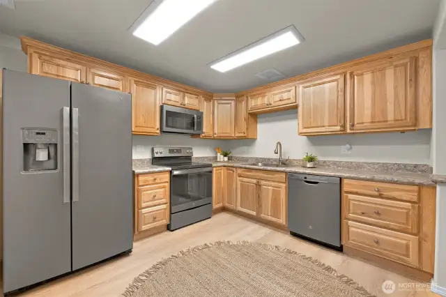 Lower level has two bedrooms, a full bath, living room, private entrance, and this big kitchen.