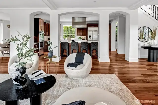 Luxury kitchen and dining room are framed by elegant architectural columns that define the spaces while preserving the effortless flow.