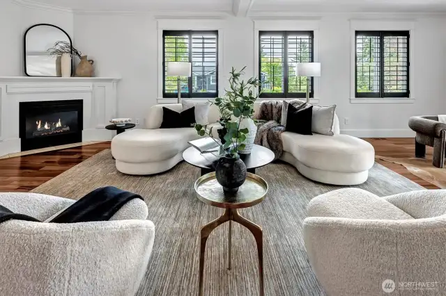 Expansive Great Room features a gas burning fireplace, walls of windows and French Doors leading to a private deck.