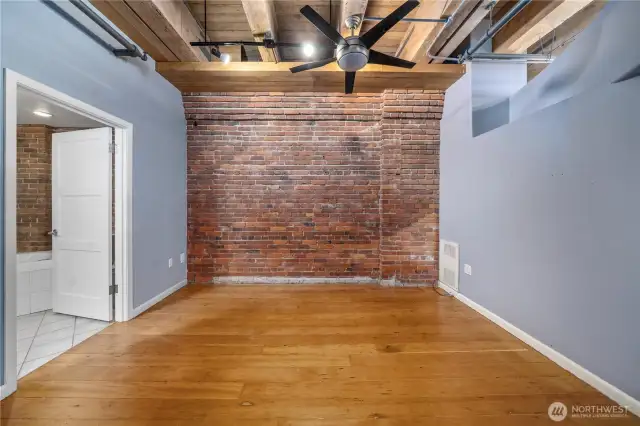 The bedroom space or office. Bathroom with tile floors to the left in this picture.