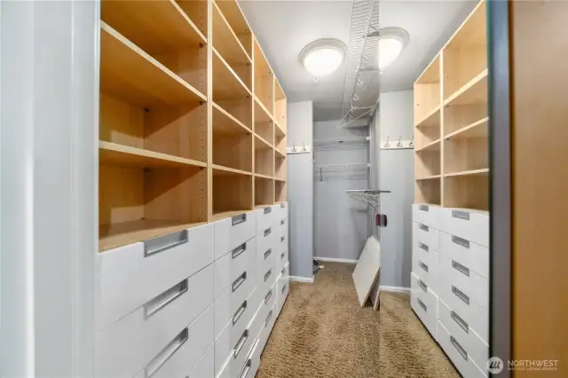 What a closet. Maximum shelving, hanging space and drawers to it all.