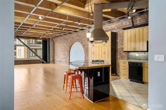 Lovely kitchen with gas cooktop, designer hood, and custom cabinets.