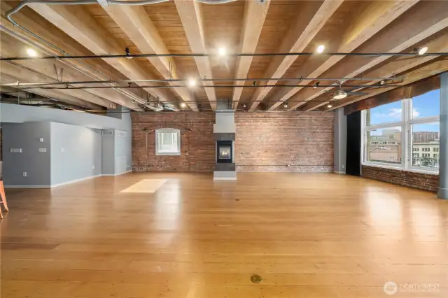 Open beamed ceiling with sufficient lighting for office or home. Three ceiling fans as well.