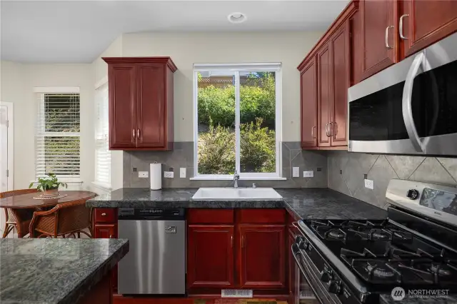 Spacious Kitchen with cherry cabinets and granite counters.