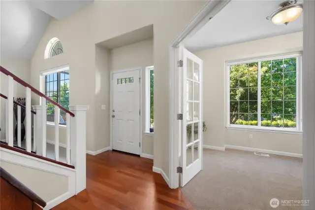 View of entry and French doors leading to large Den/Office with brand new carpet.