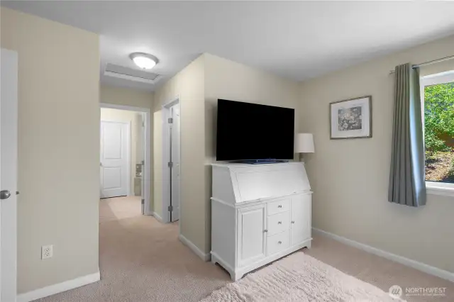 View of Primary Bedroom into the Primary 5-piece Bathroom. Walk-in closet door on the right.