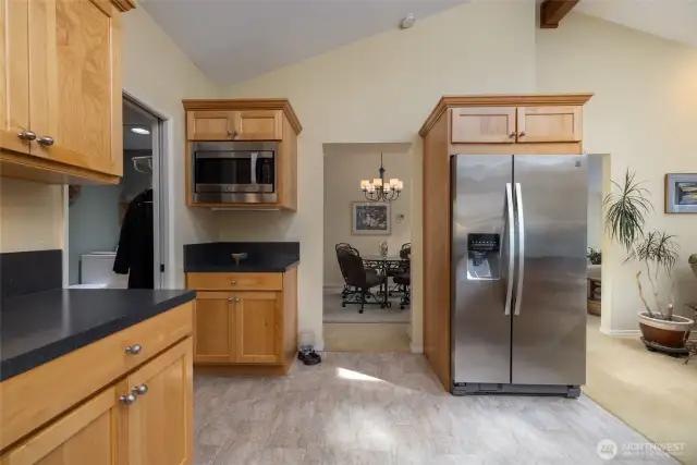 Kitchen has a microwave nook and looks into the dining room.