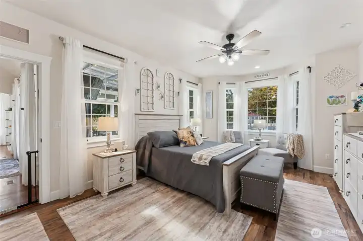 Primary bedroom with new lvp flooring, walk in lcoset with built in