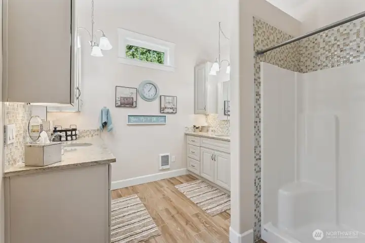 New spa bathroom, new soft close vanities with lvp flooring & electrical plug ins in the cabnetry