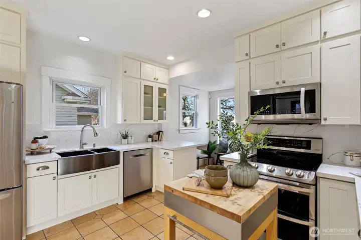 Newer stainless steel appliances including a double oven, Bosch dishwasher, LG microwave / hood and double undermount stainless steel sink.