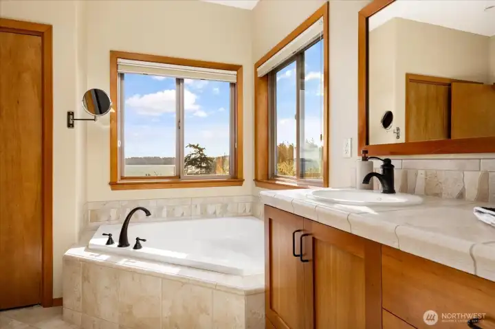 In the ensuite bath, treat yourself to a luxurious tub with a view. Completely private and serene.