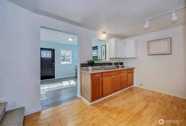 Multipurpose area featuring a utility sink and integrated laundry closet. Located between the entry and living room, this high-function zone offers the perfect 'drop-and-clean' spot for a busy lifestyle.