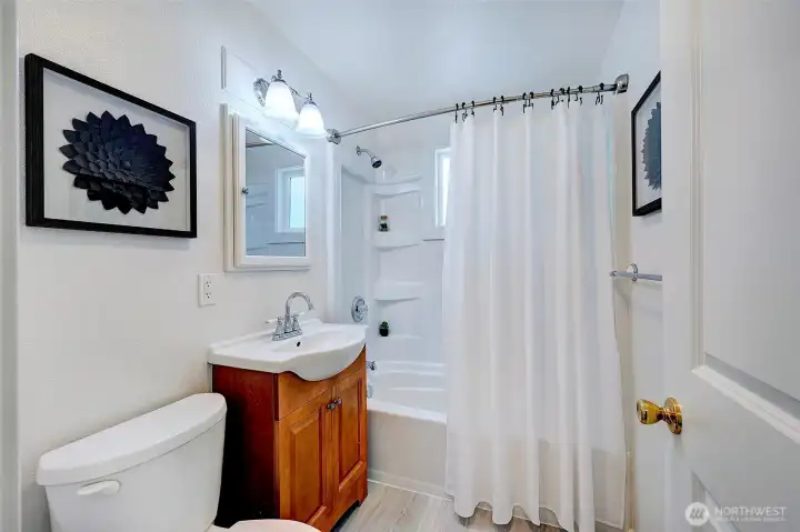 Full downstairs bathroom with new flooring.