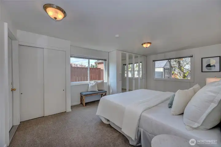 A serene downstairs retreat! This spacious bedroom features plush new carpeting, neutral tones, and a private door leading directly to the backyard. Perfect for enjoying a quiet breeze or easy access to the outdoor living space.