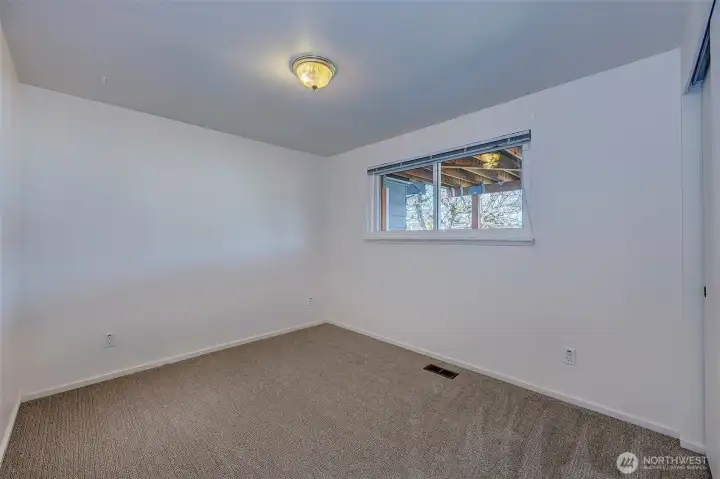 Bedroom #3 on the main floor With plenty of natural light offers a clean slate for your personal touch.