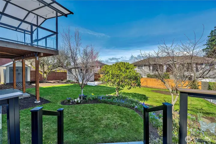 Step out onto the expansive lower deck to take in the year-around color of hundreds bulbs and beautiful flowering trees.