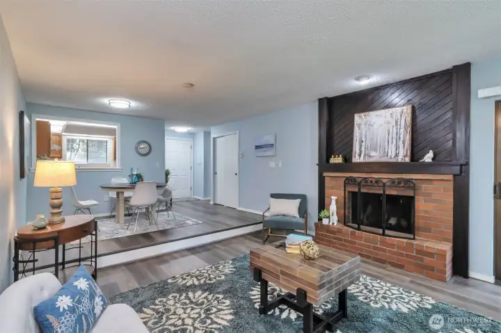 Wood burning fireplace.  You can store your firewood in your carport.  Step down from dining room has a light which is a great safety factor.