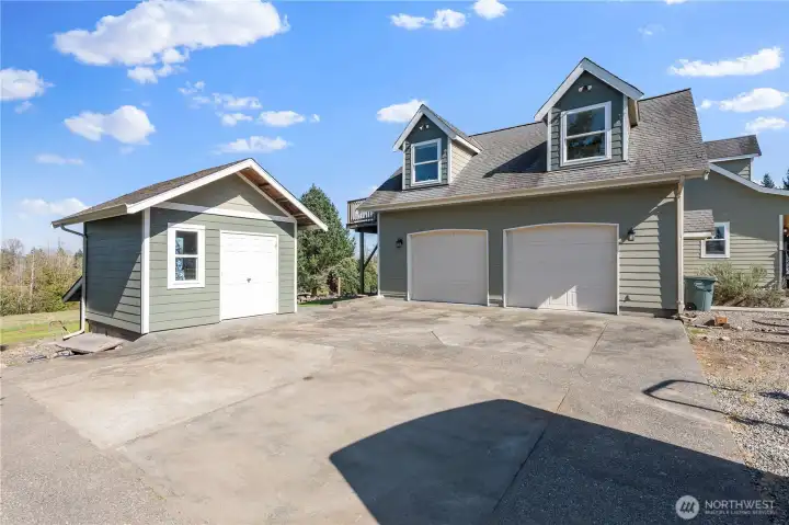 Two car attached garage  and detached shop.  Lower back level of shop is covered and a perfect spot for mowers/yard tools.