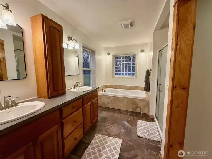 Primary bath with soaking tub, shower and dual vanity.