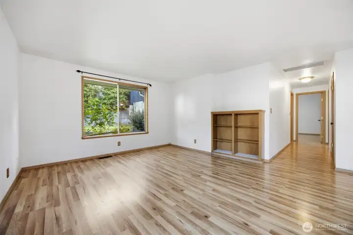 Looking across the living room with the hallway leading to the two bedrooms and the updated bathroom.