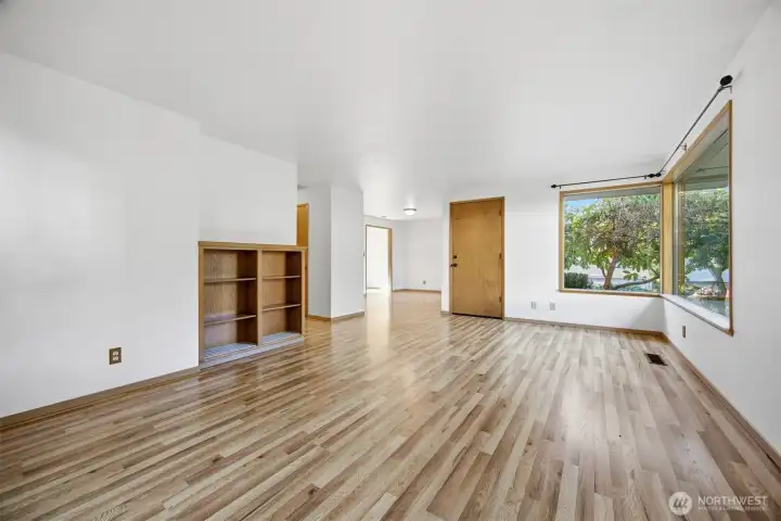 Looking across the spacious living room toward the dining area with the kitchen beyond.