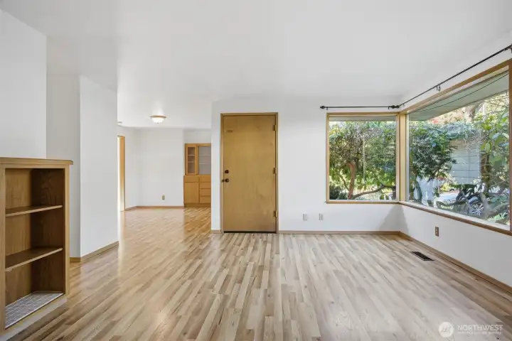 There are beautiful corner windows that look out to the landscape on one side of the front entry and a spacious dining area to the other side.