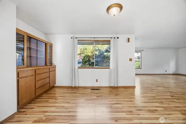 Looking across the large dining room toward the living room and entry.