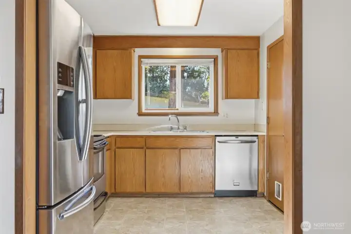 The kitchen has an abundance of cabinets and counter space along with stainless steel appliances.