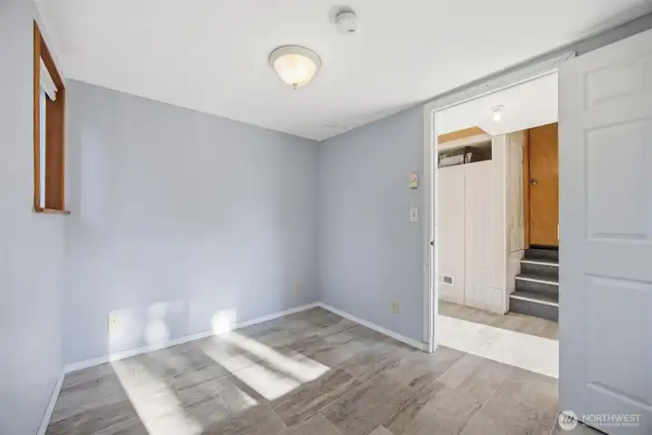 Another view from the extra finished room toward the door leading to the kitchen.