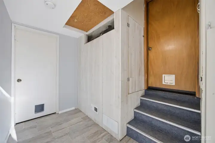 Looking at the transition from the kitchen to the garage and the extra finished room.