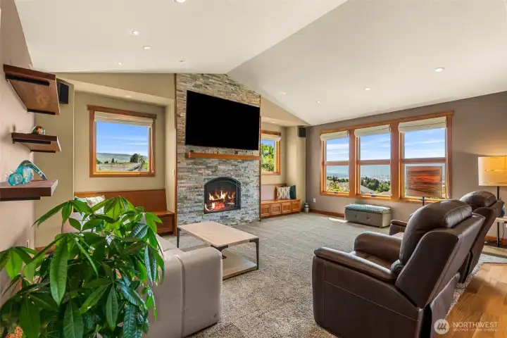 Vaulted ceilings and walls of windows fill the space with natural light,