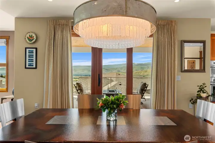 The dining area is highlighted by designer lighting and direct access to outdoor living, blending comfort, functionality, and elevated Northwest style.