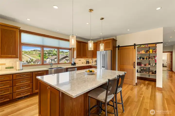 Thoughtfully designed with abundant storage, expansive prep areas, and natural light, the kitchen serves as a refined gathering space at the heart of the home.
