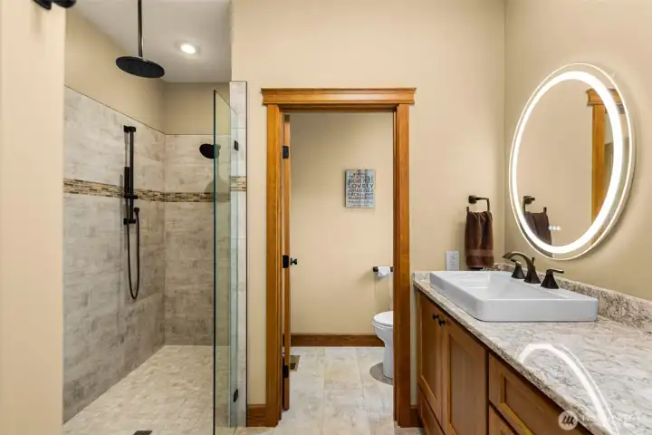 Primary bath featuring dual vanities with expansive countertop space,