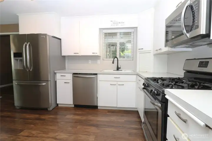 The spacious kitchen offers ample cabinetry and flows effortlessly into both living areas and a dining area The spacious kitchen offers ample cabinetry and flows effortlessly into both living areas and a dining area