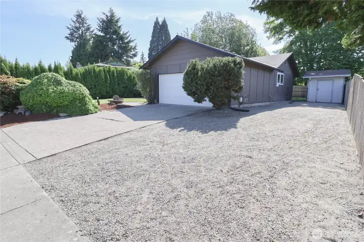 Enjoy an attached two-car garage, extended driveway, RV parking, and a tool shed Enjoy an attached two-car garage, extended driveway, RV parking, and a tool shed